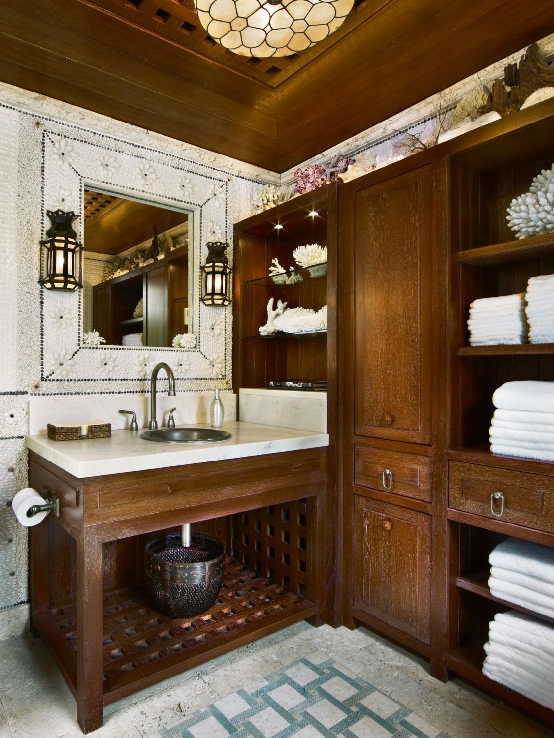 Floral motifs on the mirror and pendant light are among the ornate details in this bathroom in the pool house