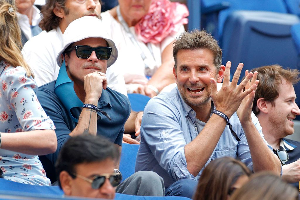 NEW YORK, NEW YORK - SEPTEMBER 12: (L-R) Actors Brad Pitt and Bradley Cooper watch the Men's Singles final match between Daniil Medvedev of Russia and Novak Djokovic of Serbia on Day Fourteen of the 2021 US Open at the USTA Billie Jean King National Tennis Center on September 12, 2021 in the Flushing neighborhood of the Queens borough of New York City. (Photo by Sarah Stier/Getty Images)