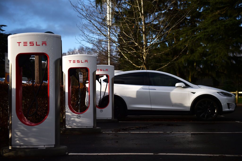 STOKE ON TRENT, ENGLAND - DECEMBER 10: A Tesla car is charged at an electric vehicle charging pod point at Trentham Estate on December 10, 2021 in Stoke on Trent, England. (Photo by Nathan Stirk/Getty Images)