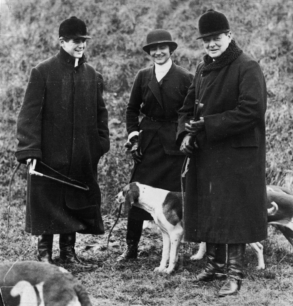 On right, Winston Churchill (1874 - 1965) accompanied by his son Randolph (1911 - 1968) and Coco Chanel (1883 - 1971) at a meet of the Duke of Westminster's boar hounds, the 'Mimizan Hunt' near Dampierre, northern France. (Photo by Hulton Archive/Getty Images)