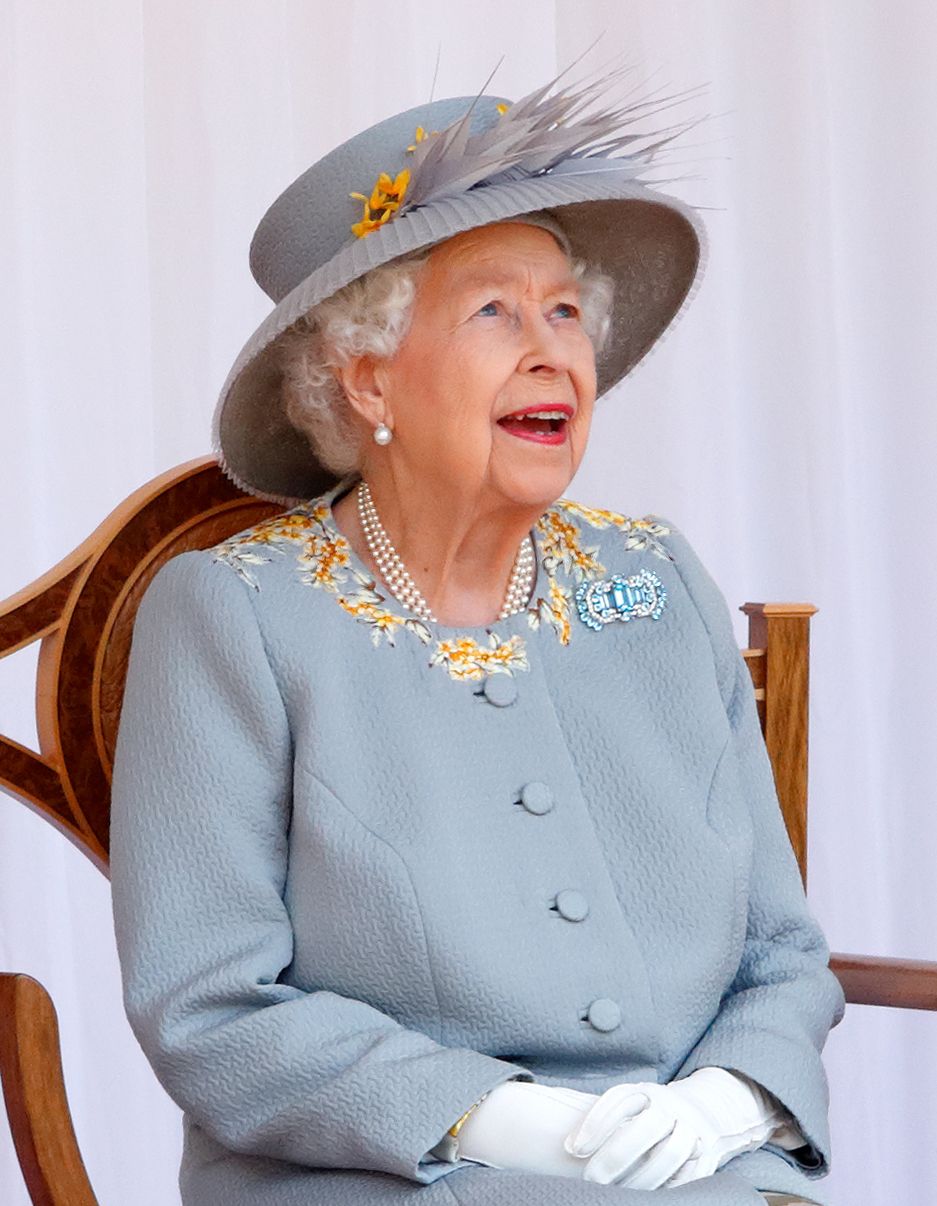 WINDSOR, UNITED KINGDOM - JUNE 12: (EMBARGOED FOR PUBLICATION IN UK NEWSPAPERS UNTIL 24 HOURS AFTER CREATE DATE AND TIME) Queen Elizabeth II (wearing her Aquamarine Art Deco Brooch, which belonged to Queen Elizabeth, The Queen Mother) watches a flypast by the RAF Red Arrows as she attends a military parade, held by the Household Division (during which The Queen's Colour of F Company Scots Guards will be trooped) in the Quadrangle of Windsor Castle, to mark her Official Birthday on June 12, 2021 in Windsor,