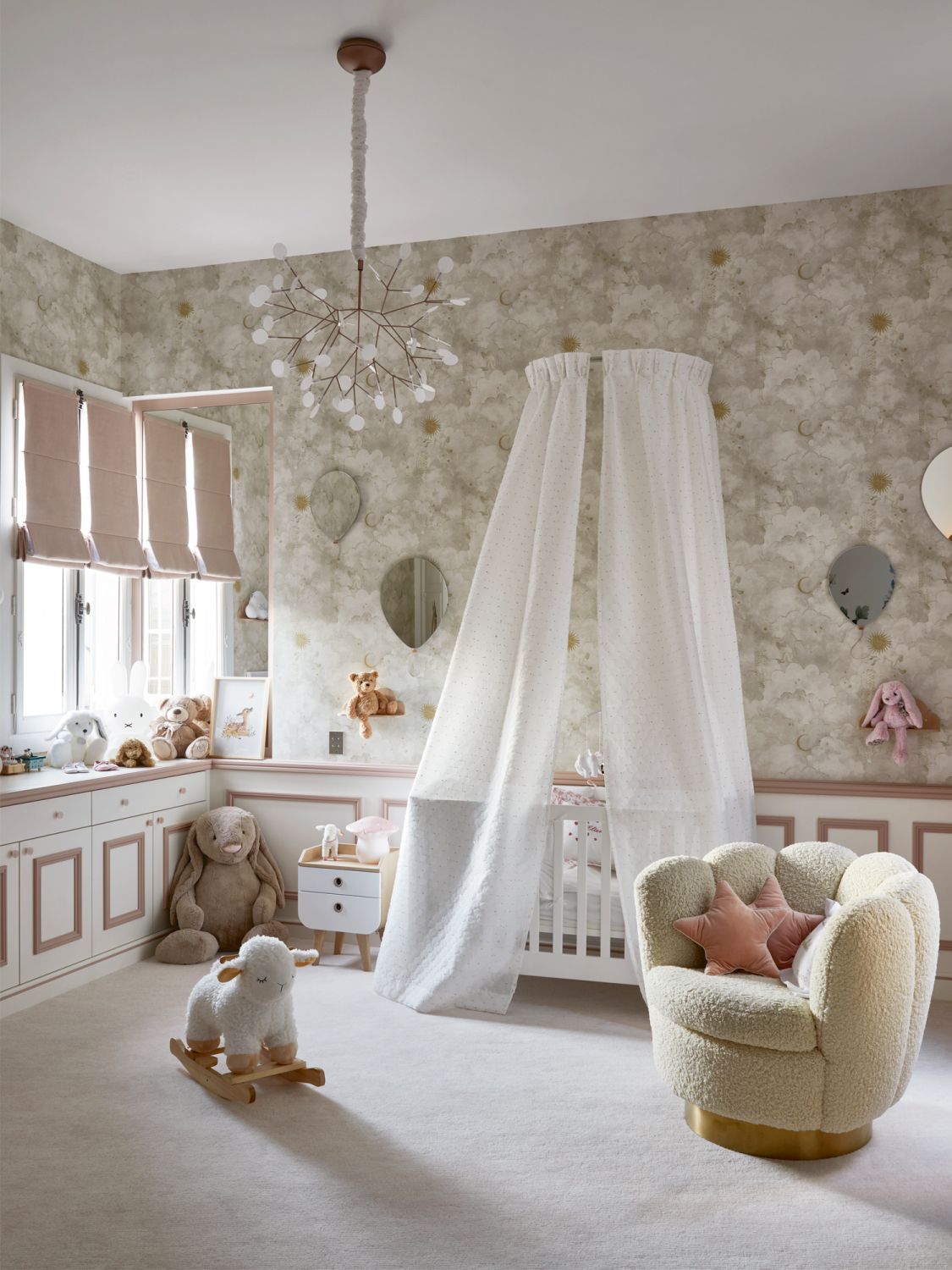 A Moooi Heracleum II hanging lamp floats overhead in the nursery, which is furnished with a cuddly armchair from Eichholtz, and the Stars and Monkeys wallpaper from Les Dominotiers