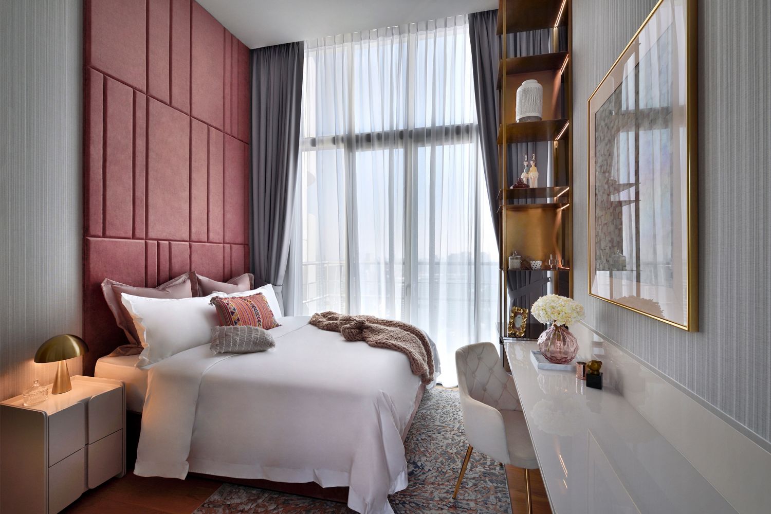 The pink headboard adds a pop of colour and contributes to the lively look of the space