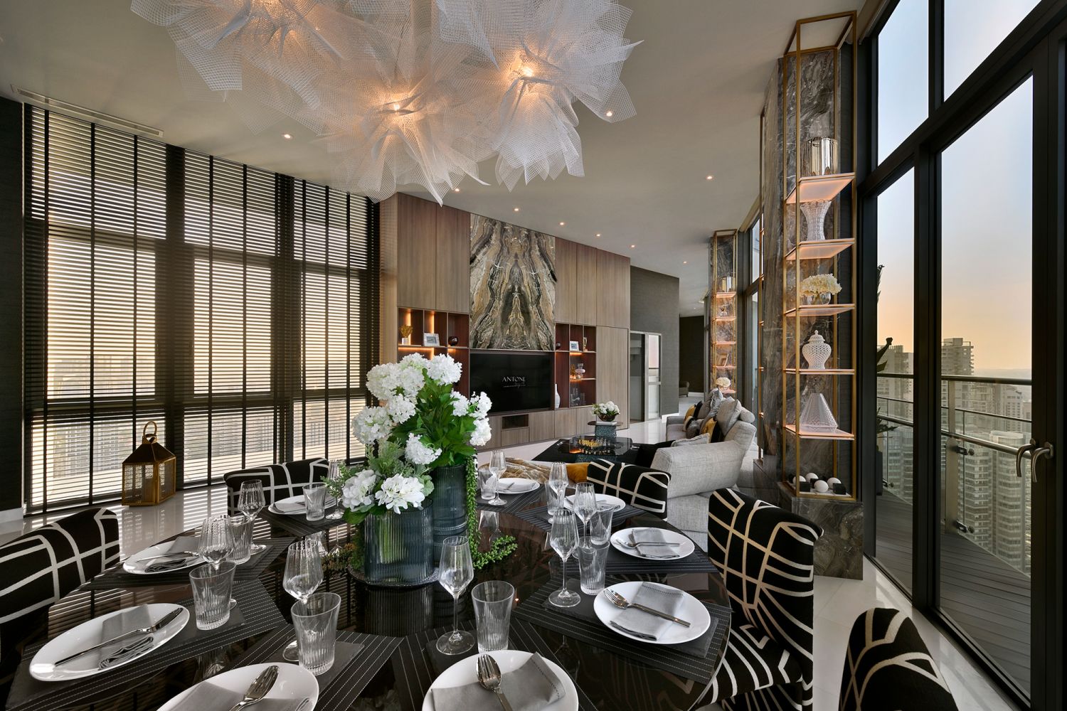 The focal point in the living and dining area is the marble feature TV wall, which doubles as a glamorous storage unit