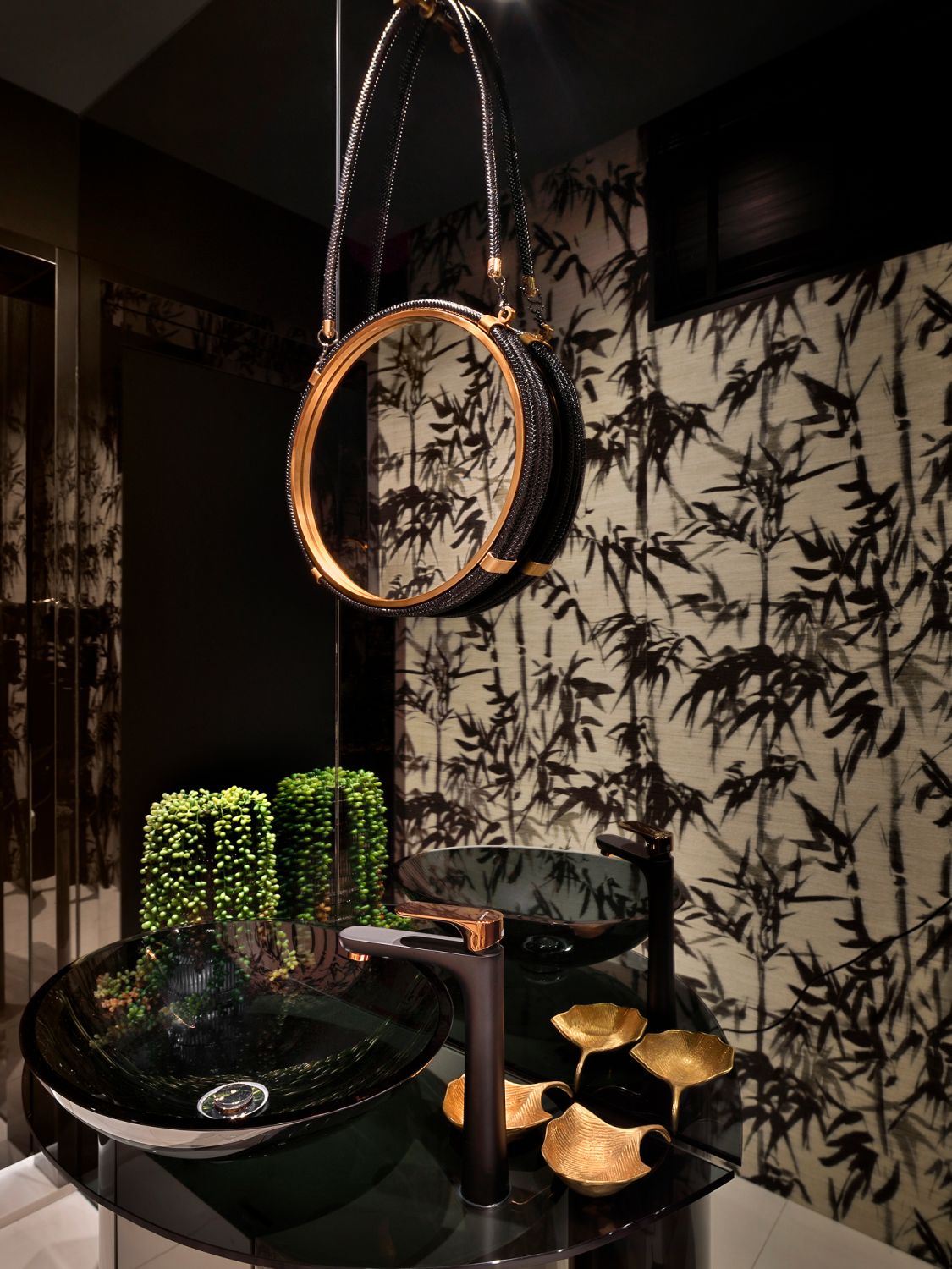 Exuding a moody ambience, the powder room is clad with luxurious touches