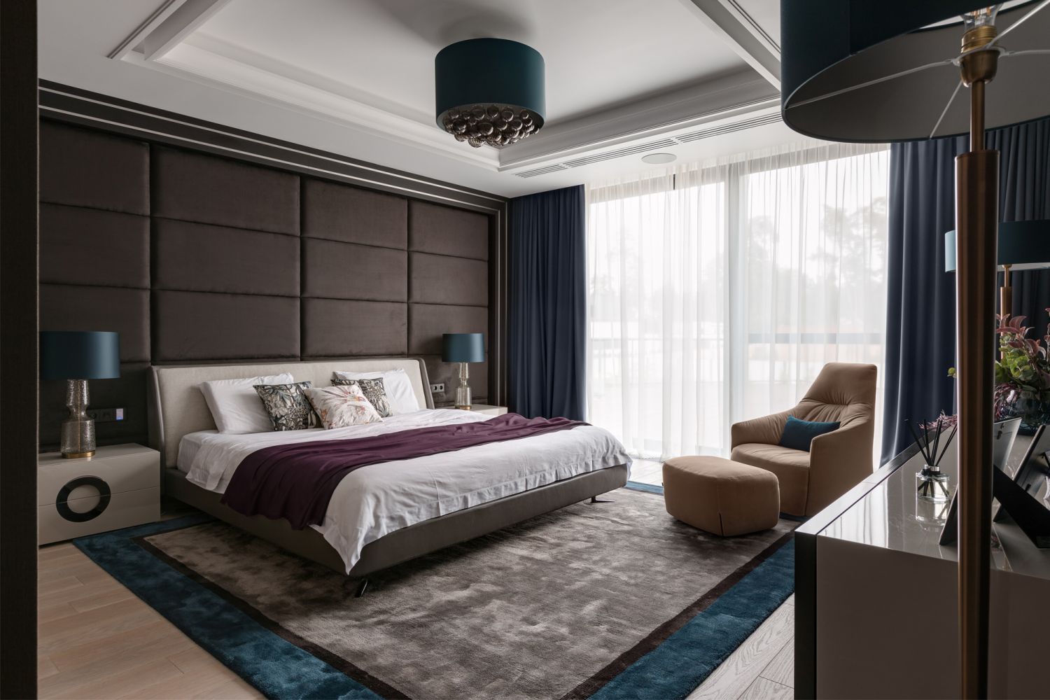 Designed by Bolshakova Interiors, the dark tones and velvet headboard in this room conveys a sense of relaxation (Photo: Audrey Adveenko)