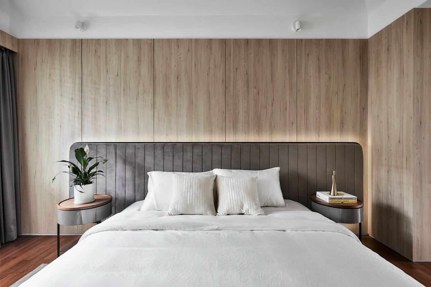 The master bedroom in this home designed by Akihaus features wood panels that offer warmth (Photo: Wong Weiliang/328 Productions)