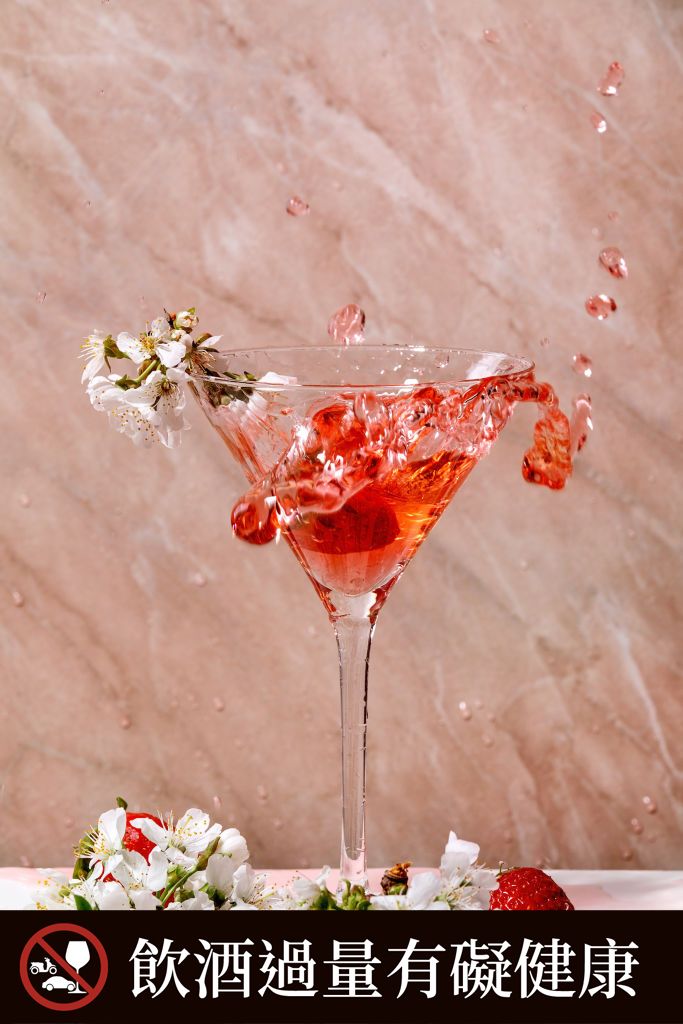 Splash of strawberry alcoholic or non-alcohol cocktail in martini glass decorated with blooming branches of cherry tree over white and pink texture background. (Photo by: Natasha Breen/REDA&CO/Universal Images Group via Getty Images)