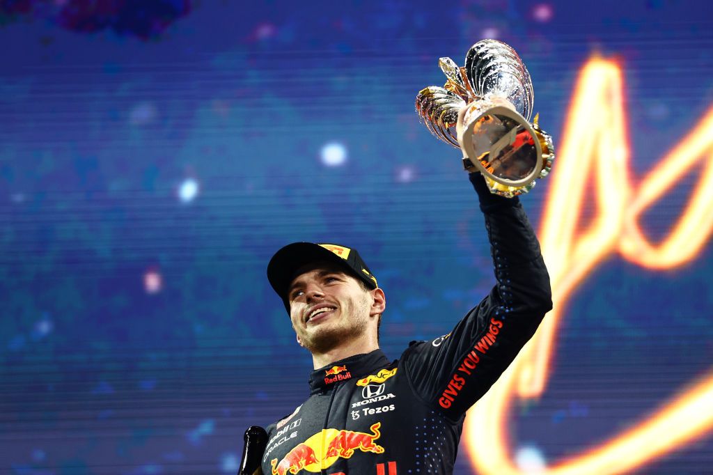 ABU DHABI, UNITED ARAB EMIRATES - DECEMBER 12: Race winner and 2021 F1 World Drivers Champion Max Verstappen of Netherlands and Red Bull Racing celebrates on the podium during the F1 Grand Prix of Abu Dhabi at Yas Marina Circuit on December 12, 2021 in Abu Dhabi, United Arab Emirates. (Photo by Mark Thompson/Getty Images)