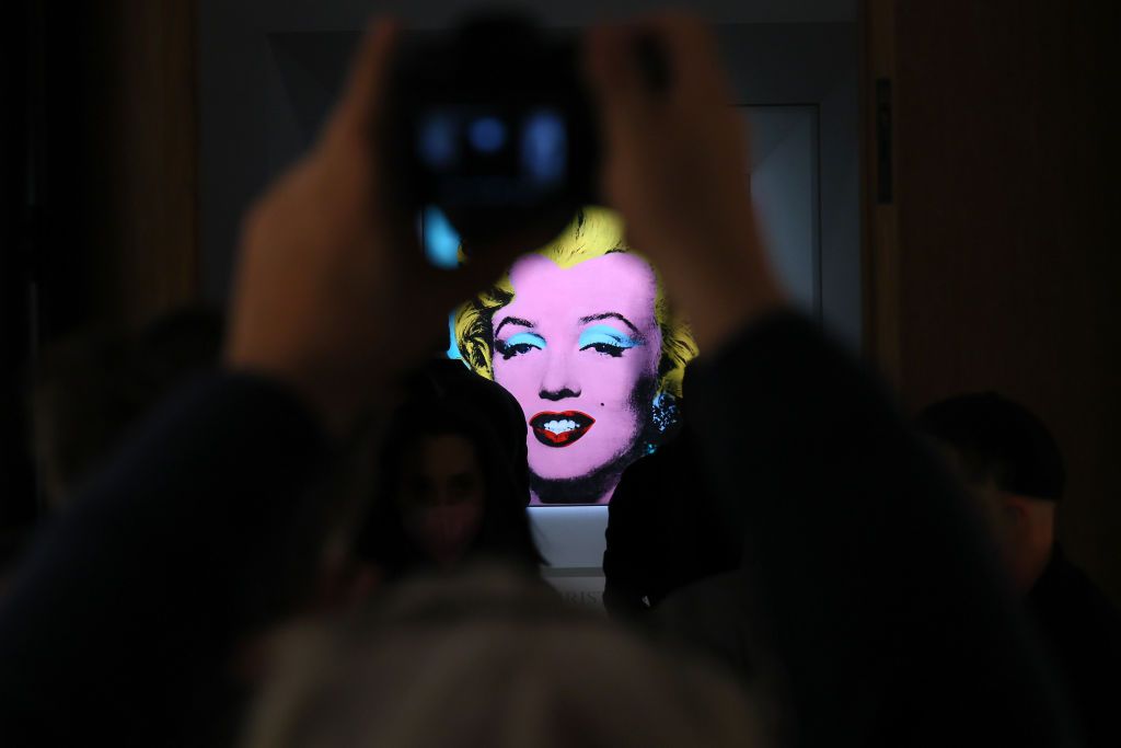 NEW YORK, NEW YORK - MARCH 21: A guest takes a photo during Christie's announcement that they will offer Andy Warholâs Shot Sage Blue Marilyn painting of Marilyn Monroe at Christieâs on March 21, 2022 in New York City. The work comes to Christieâs from the Thomas and Doris Ammann Foundation Zurich and all proceeds of the sale will benefit the foundation. (Photo by Dia Dipasupil/Getty Images)