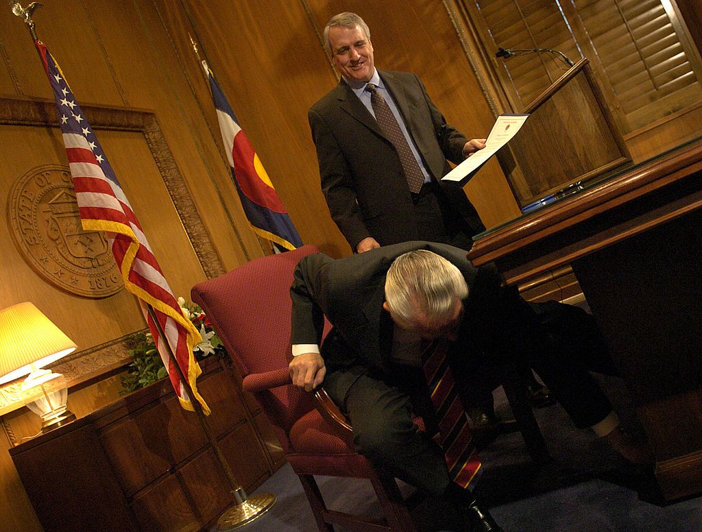 DENVER COLO JAN. 10, 2007--Governor Bill Ritter sign his first proclamation, Wednesday, Jan. 10, 2007, in his office at the State Capitol. Gov. Ritter is making January 10th Cortlandt "Cort" Dietler Day. Dietler looks for the governor's pin, under the desk, after being honored as a Citizen of the West in the proclamation. DENVER POST PHOTO BY RJ SANGOSTI (Photo By RJ Sangosti/The Denver Post via Getty Images)