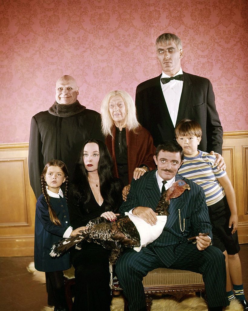 The cast of the US TV comedy horror series 'The Addams Family', circa 1965. Back row, left to right: Jackie Coogan (1914 - 1984) as Uncle Fester, Blossom Rock (1895 - 1978) as Grandmama Addams, and Ted Cassidy (1932 - 1979) as Lurch. Front row, left to right: Lisa Loring as Wednesday Addams, Carolyn Jones (1930 - 1983) as Morticia Addams, John Astin as Gomez Addams, and Ken Weatherwax as Pugsley Addams. (Photo by Silver Screen Collection/Getty Images)