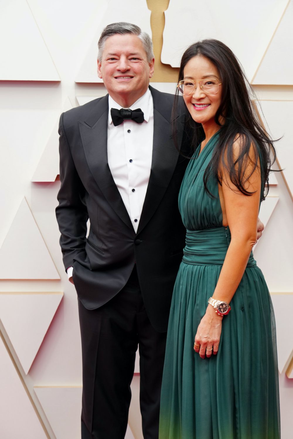 HOLLYWOOD, CALIFORNIA - MARCH 27: Chief Executive Officer of Netflix Ted Sarandos and VP, Documentary and Independent Films at Netflix Lisa Nishimura attend the 94th Annual Academy Awards at Hollywood and Highland on March 27, 2022 in Hollywood, California. (Photo by Jeff Kravitz/FilmMagic)