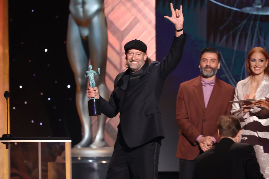 SANTA MONICA, CALIFORNIA - FEBRUARY 27: Troy Kotsur (C) accepts Outstanding Performance by a Male Actor in a Supporting Role for âCODAâ onstage during the 28th Annual Screen ActorsÂ Guild Awards at Barker Hangar on February 27, 2022 in Santa Monica, California. (Photo by Rich Fury/Getty Images)