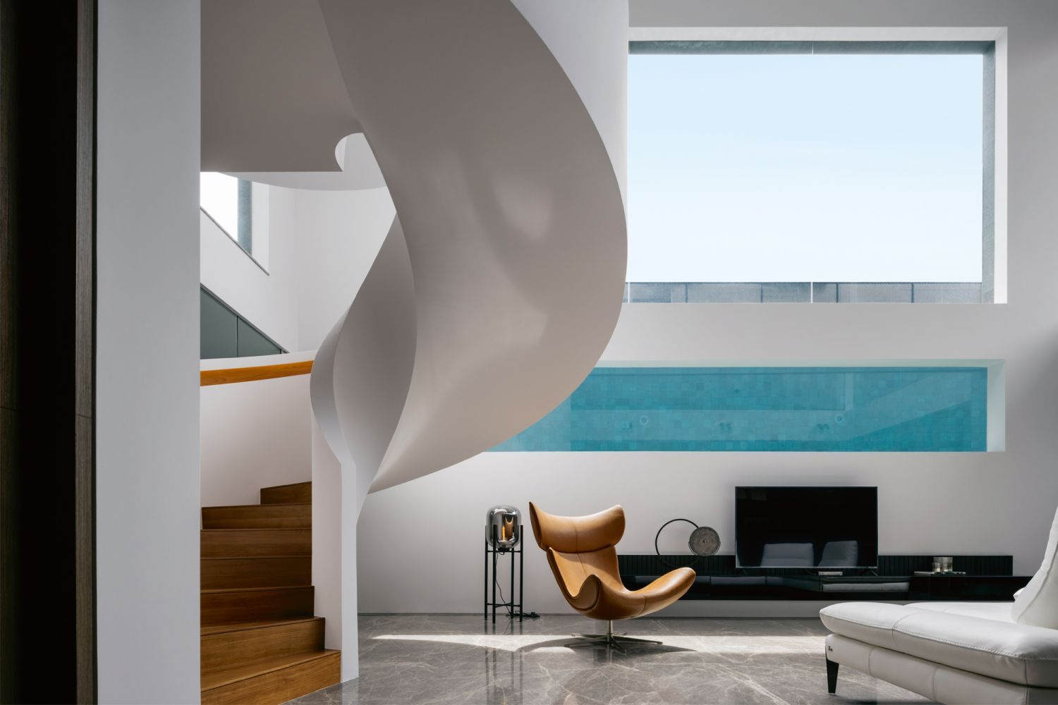 A rectangular window offers a peek into the lap pool within the basement designed by Ming Architects (Photo: Studio Periphery)