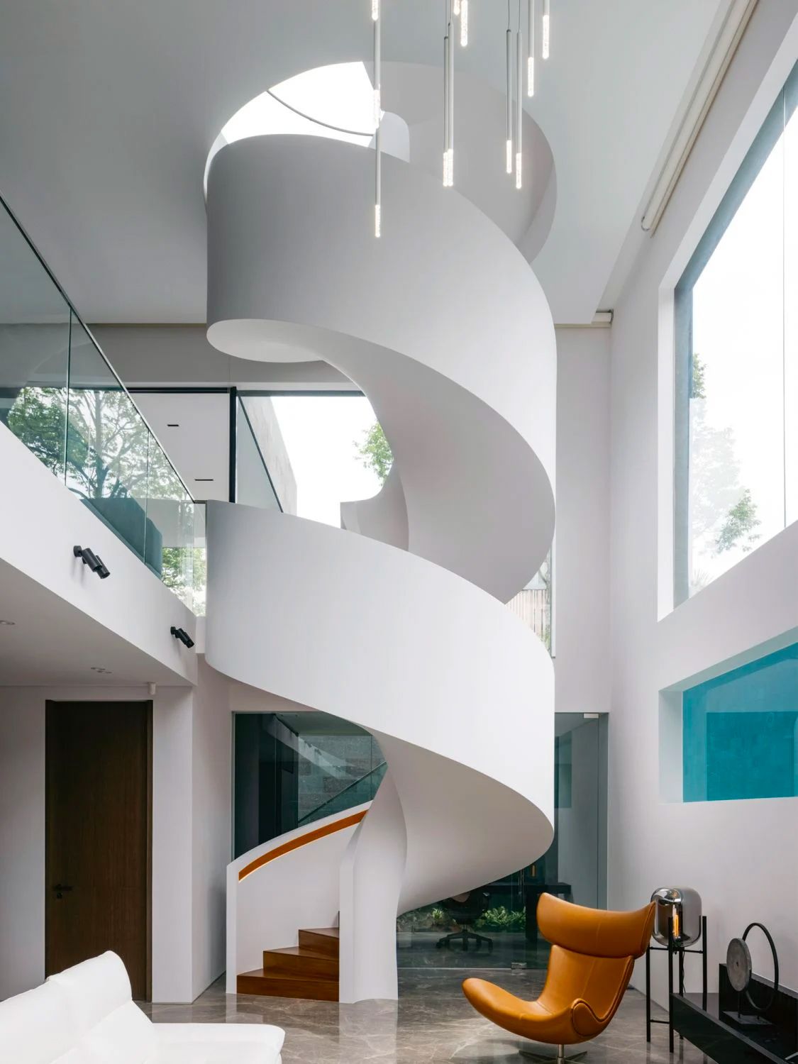 This striking spiral staircase is the centrepiece of the home (Photo: Studio Periphery)