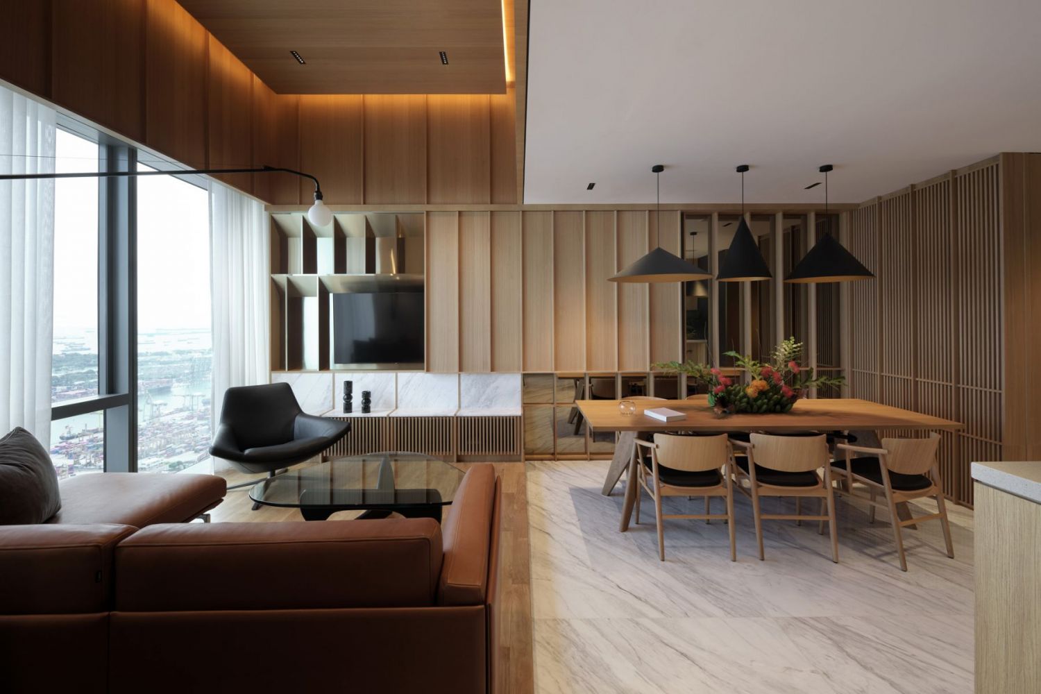 Designed by Super Assembly, this living room features a sliding panel conceals the television and hidden storage shelves (Photo: Fabian Ong)