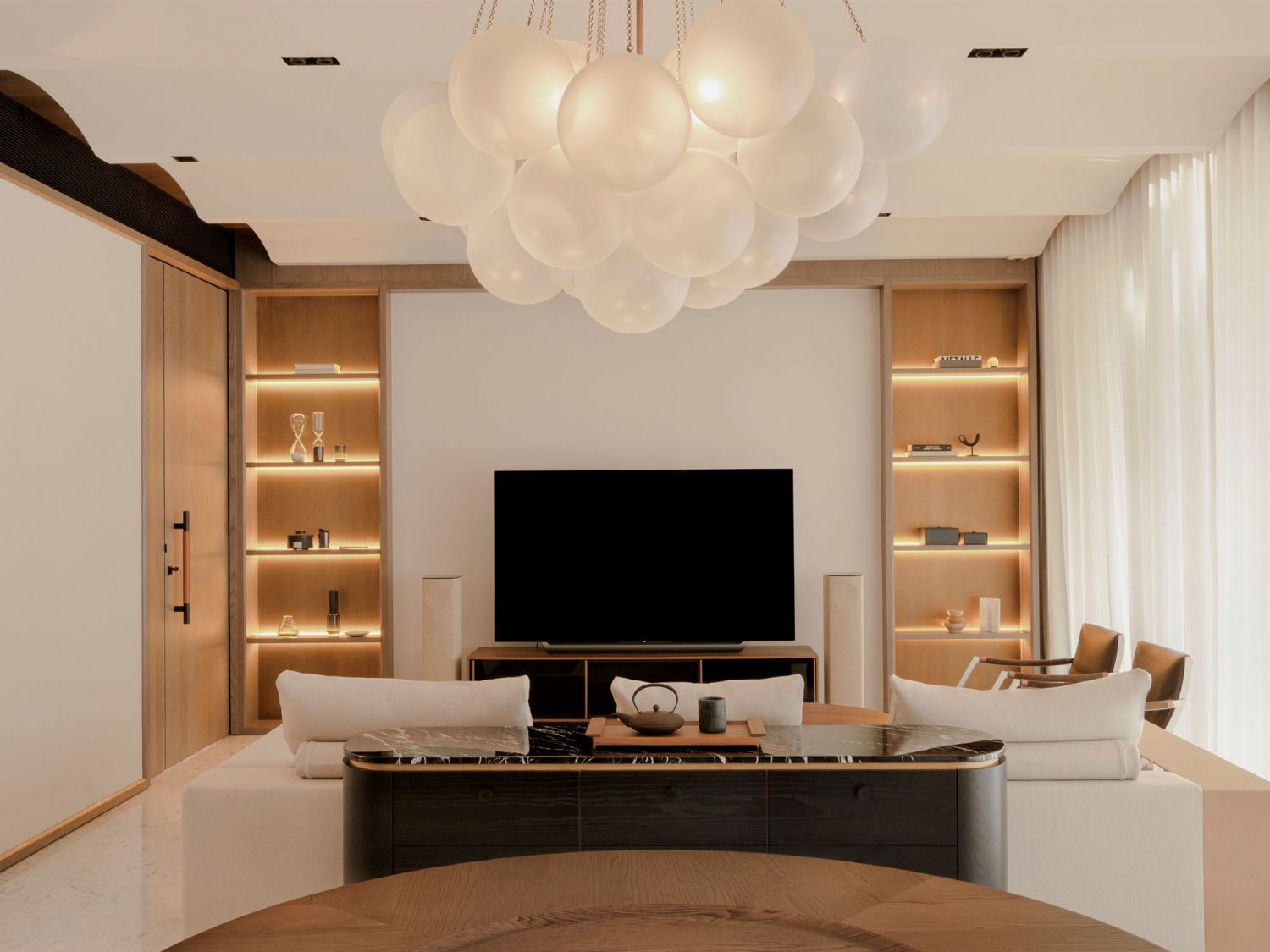 The backlit shelves in this living room by Antimatter showcase objets d’art and collectibles (Photo: Hosanna Swee)