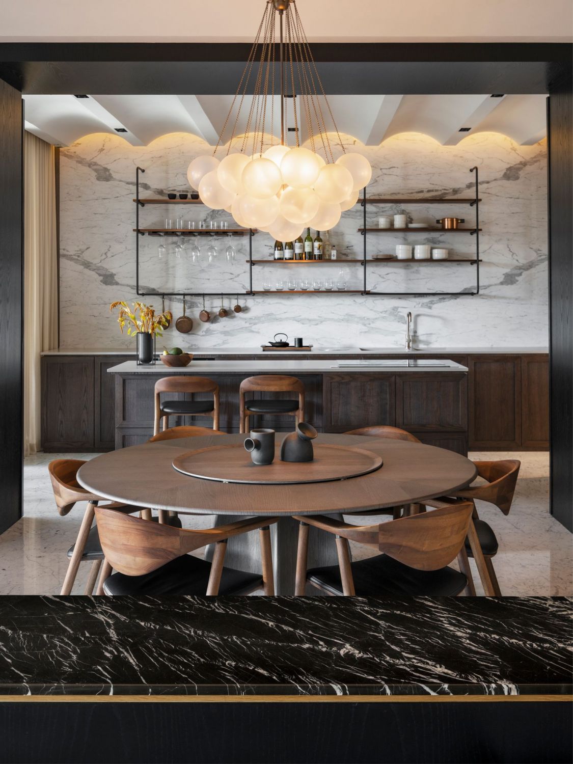Pendant lights designed by Apparatus Studio float above the Molteni&C dining table (Photo: Hosanna Swee)