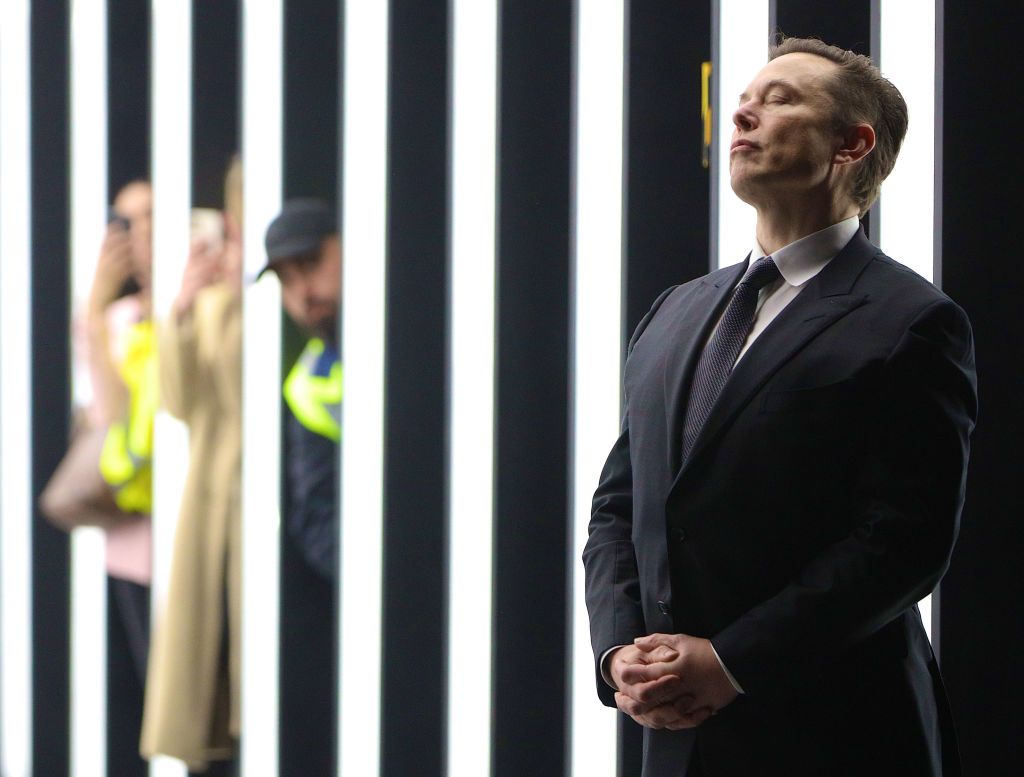 GRUENHEIDE, GERMANY - MARCH 22: (Alternate crop of #1239417601) Tesla CEO Elon Musk contemplates during the official opening of the new Tesla electric car manufacturing plant on March 22, 2022 near Gruenheide, Germany. The new plant, officially called the Gigafactory Berlin-Brandenburg, is producing the Model Y as well as electric car batteries. (Photo by Christian Marquardt - Pool/Getty Images)