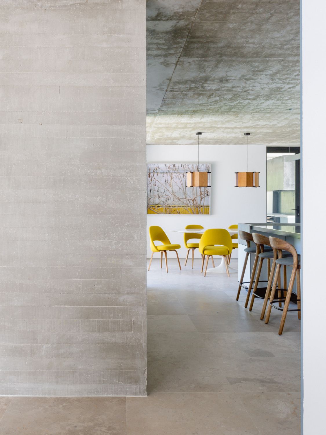 Knoll Conference chairs by Eero Saarinen add pops of colour to the dining room with their bright yellow upholstery