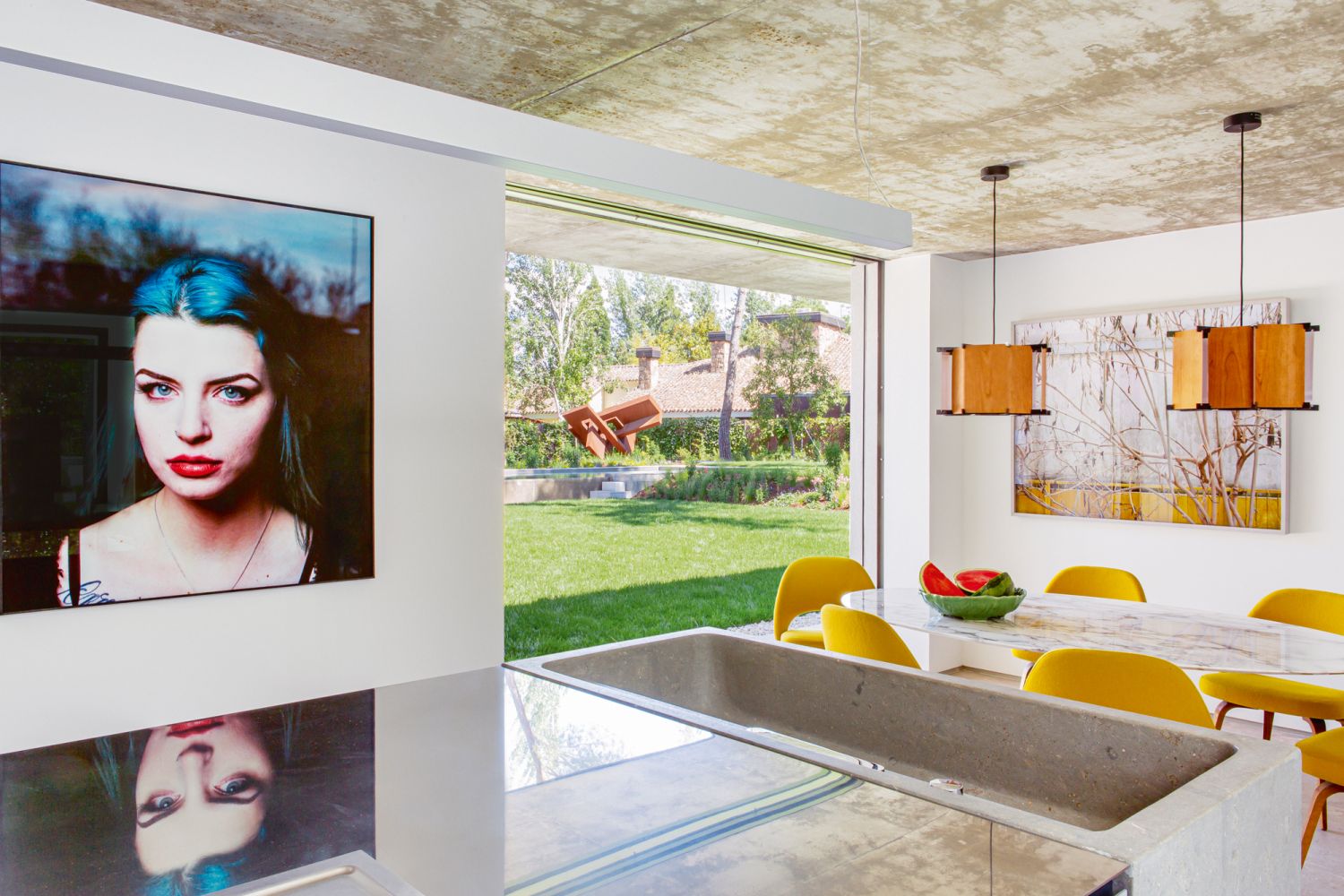The dining area and kitchen look out to lush views of the garden, which features a wide variety of perennial plants