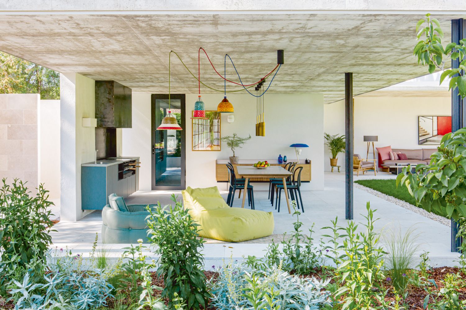 Furnished with an &Tradition table, Vitra Belleville chairs by Ronan and Erwan Bouroullec and a Punt Mobles sideboard, this barbecue area is among the family’s favourite places in the home