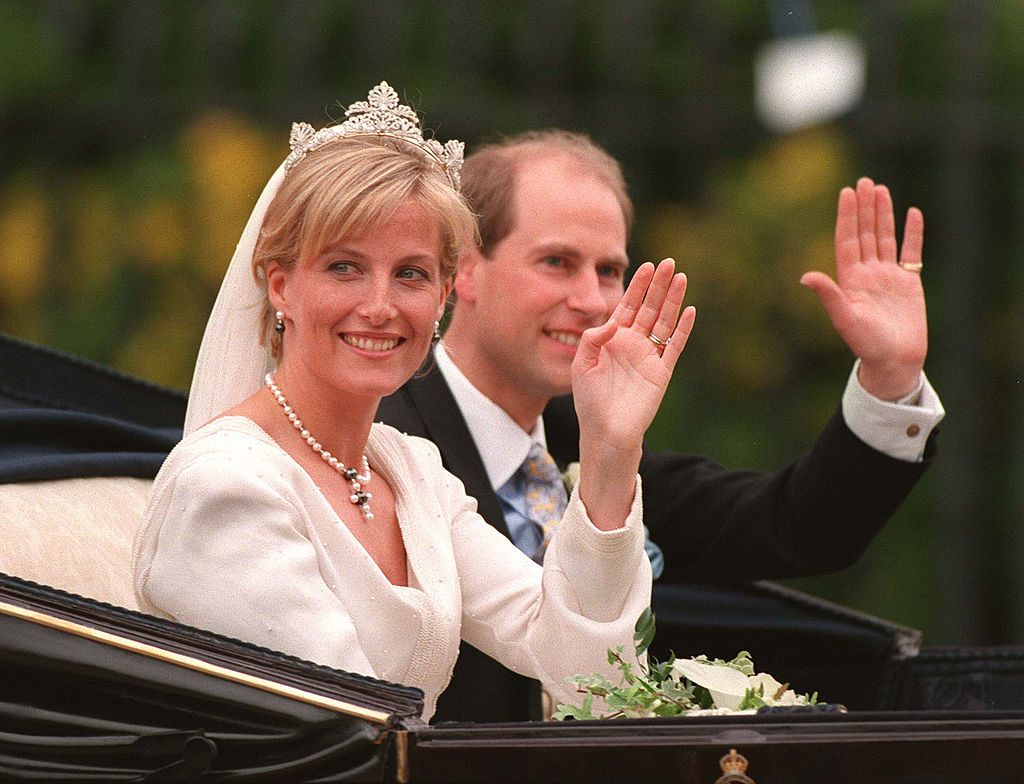 Britain's Prince Edward and Sophie Rhys-Jones wave to the crowd from an open carriage after being married in St. George's Chapel within the grounds of Windsor Castle Saturday, June 19, 1999. They are to be known as The Earl and Countess of Wessex. (Photo by UK Press)