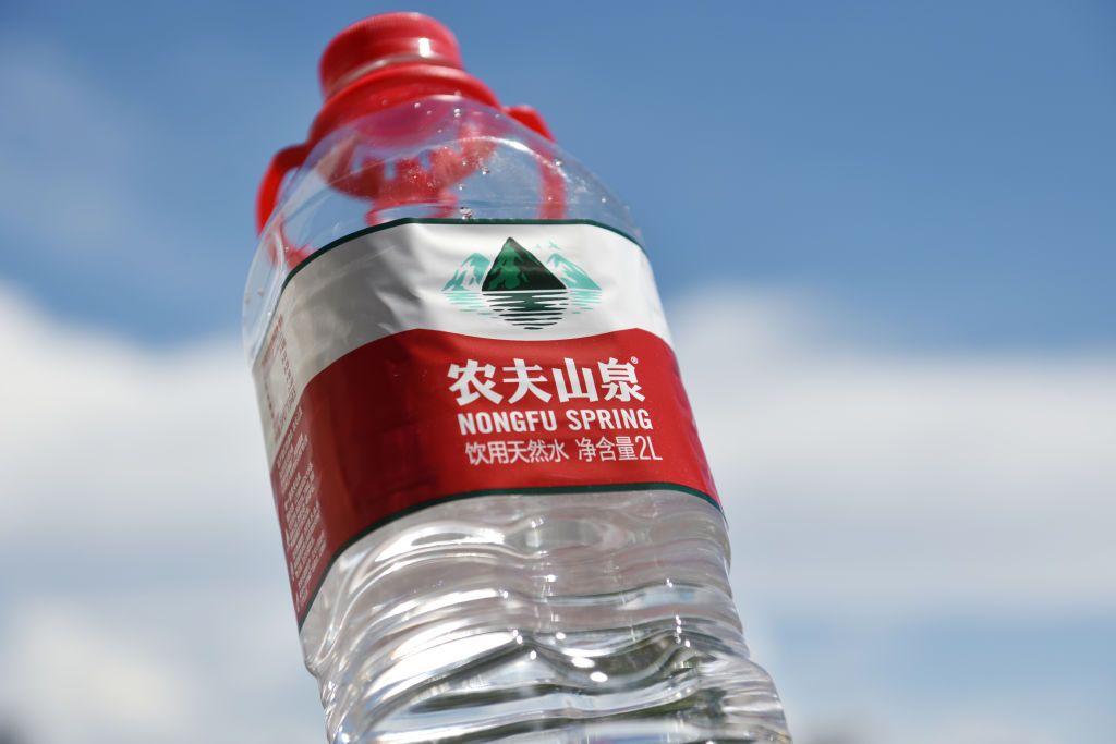 HAIKOU, CHINA - 2020/09/10: In this photo illustration, a bottle of Nongfu Spring water seen displayed outdoors.Shares of Chinese bottled water giant Nongfu Spring closed 54 percent above their issue price on debut in Hong Kong, after soaring nearly 85 percent at the open on Tuesday and making its founder Zhong Shanshan one of the wealthiest men in China. (Photo Illustration by Sheldon Cooper/SOPA Images/LightRocket via Getty Images)
