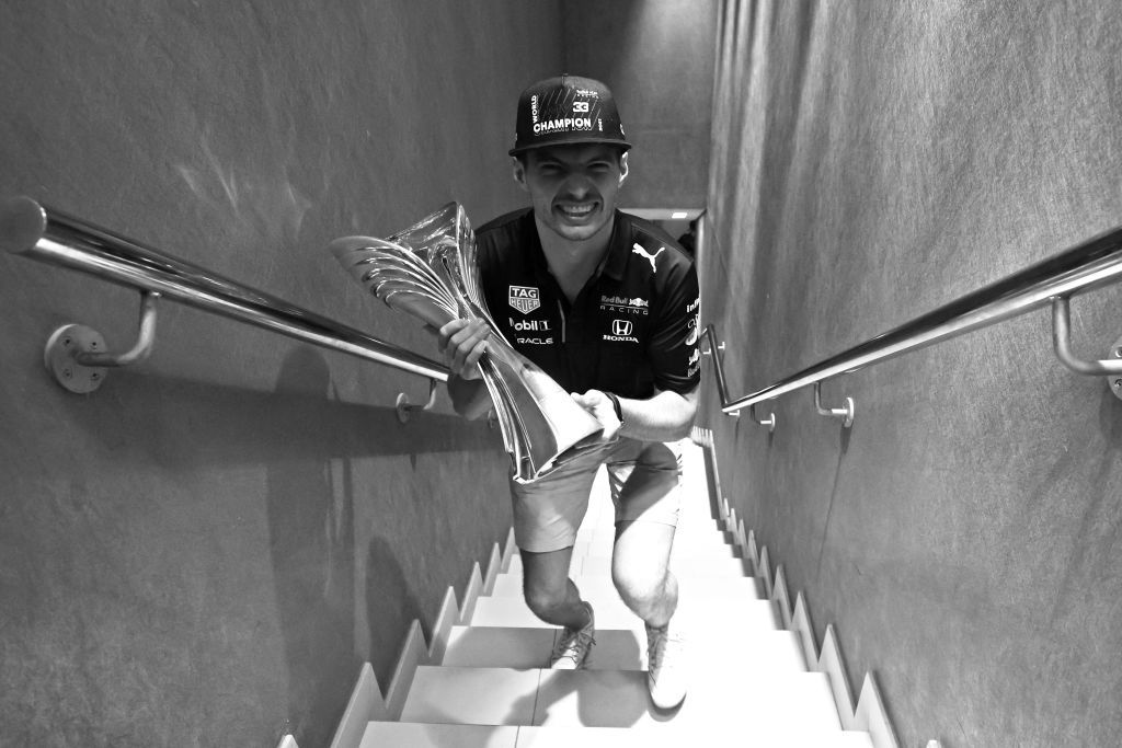 ABU DHABI, UNITED ARAB EMIRATES - DECEMBER 12: (EDITORS NOTE: Image has been converted to black and white.) Race winner and 2021 F1 World Drivers Champion Max Verstappen of Netherlands and Red Bull Racing celebrates with his trophy after the F1 Grand Prix of Abu Dhabi at Yas Marina Circuit on December 12, 2021 in Abu Dhabi, United Arab Emirates. (Photo by Mark Thompson/Getty Images)