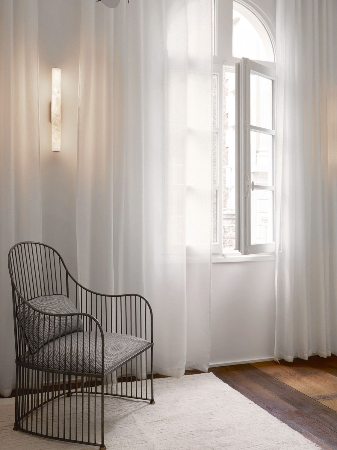 A vintage chair from Galerie Bellechasse 29 creates a reading nook in the hallway