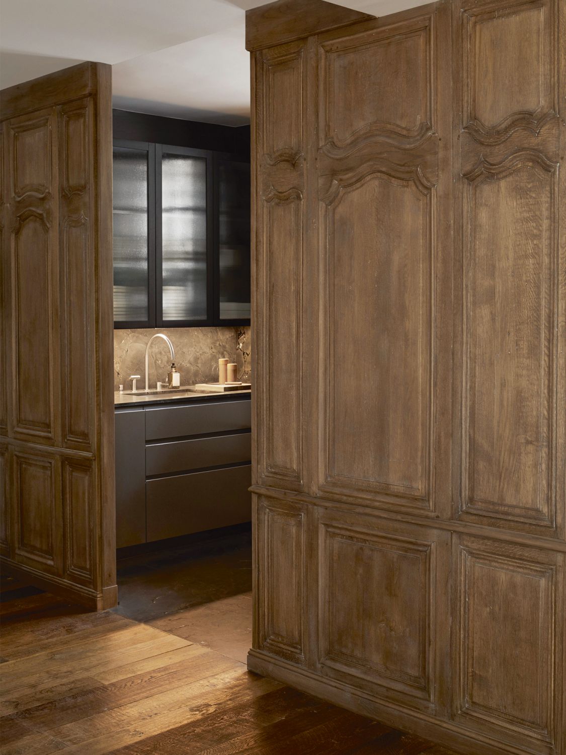 The kitchen features cabinetry designed by Émilie Bonaventure and an oak wood door and walls from the 18th century