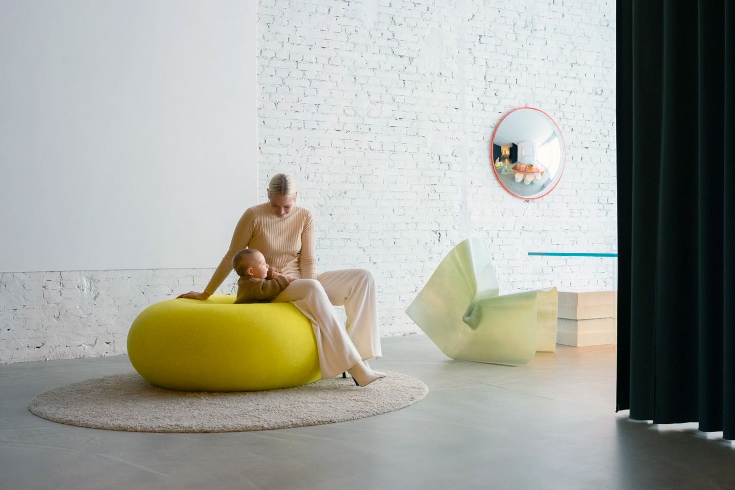 Marcelis together with her child on the Hem Boa pouf (Photo: Titia Hahne, via Hem)