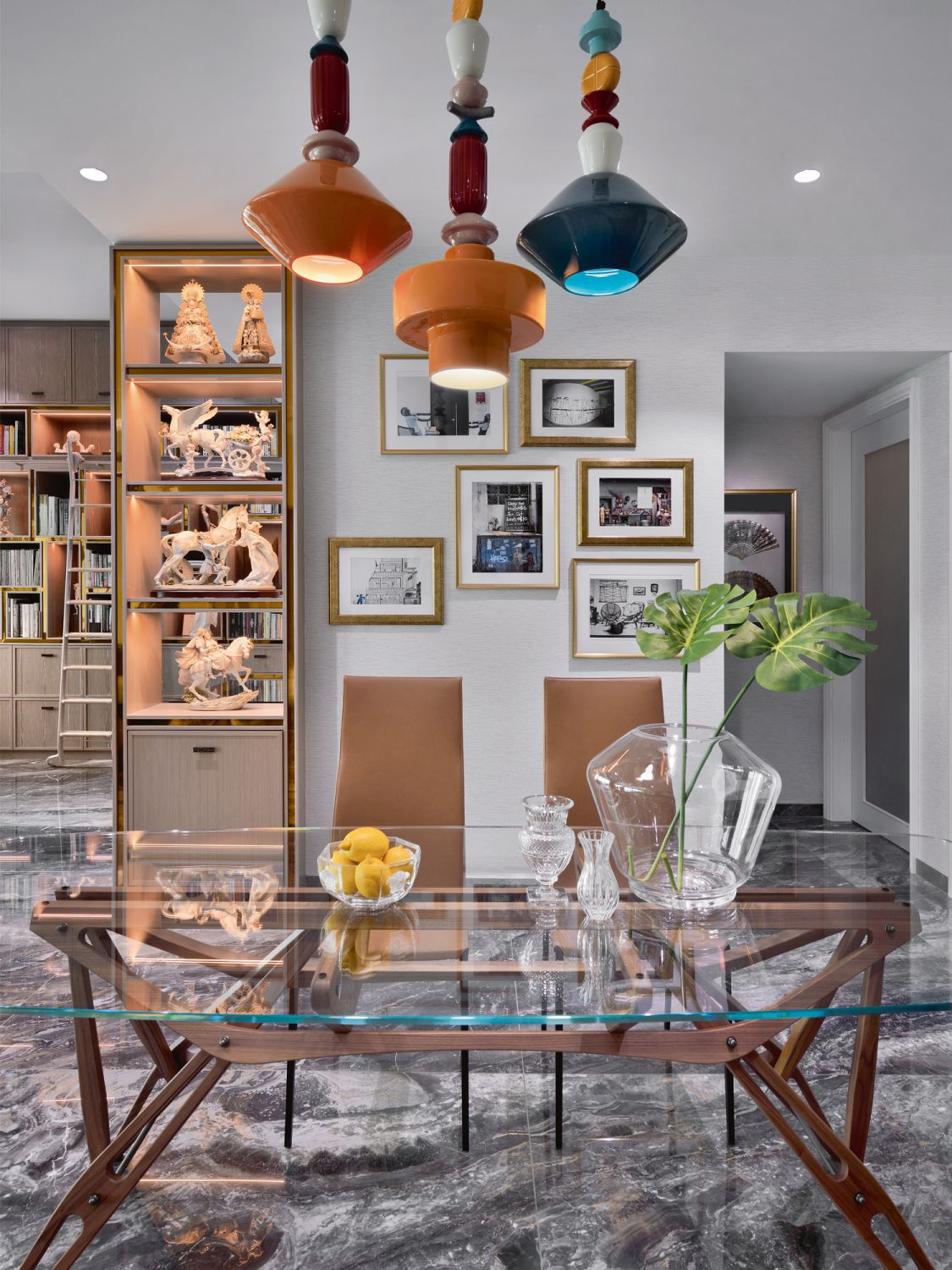 Ferroluce lamps and framed photos taken by the husband catch the eye in the dining area