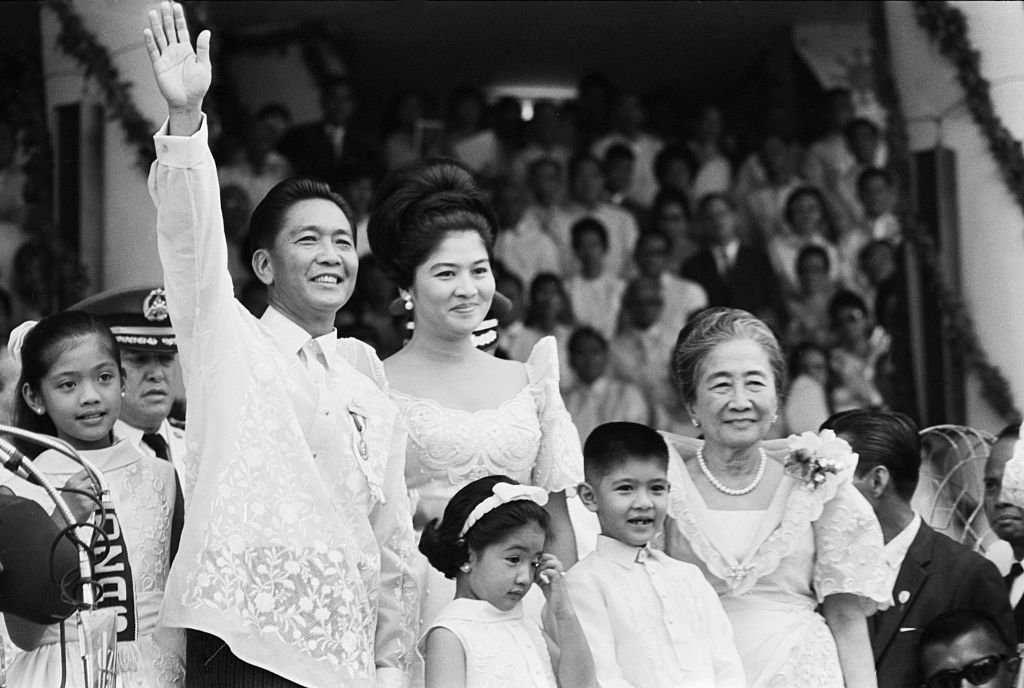 Standing with his family, Ferdinand Marcos waves to the crowd after his inauguration as the President of the Philippines on December 30, 1965