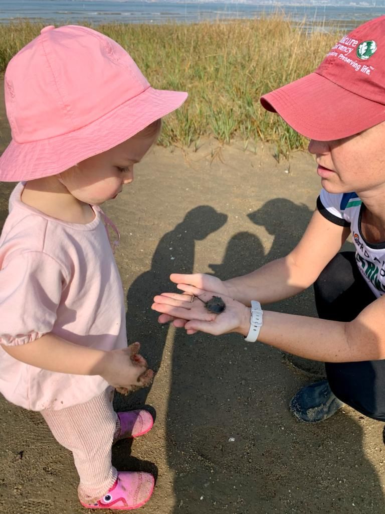 Marine Thomas with her daughter and a horseshoe crab