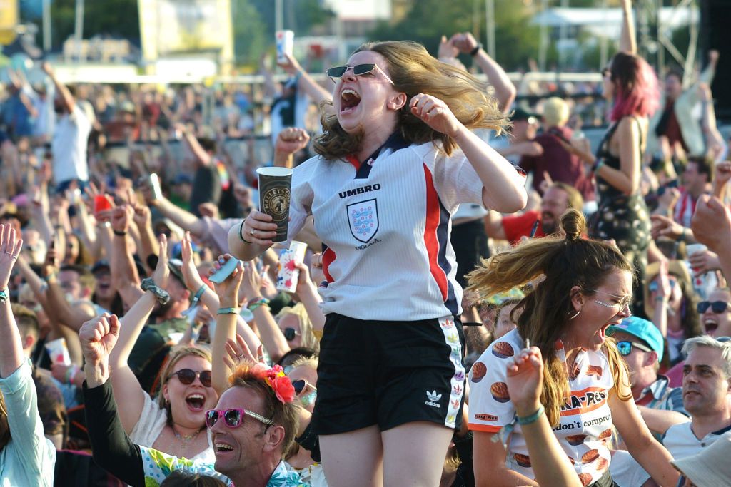 GLASTONBURY, ENGLAND - JUNE 27:  England fans celebrate the first goal of the Women's World Cup Quarter Final between England and Norway, during day two of Glastonbury Festival at Worthy Farm, Pilton on June 27, 2019 in Glastonbury, England. The festival, founded by farmer Michael Eavis in 1970, is the largest greenfield music and performing arts festival in the world. Tickets for the festival sold out in just 36 minutes as it returns following a fallow year. (Photo by Jim Dyson/Getty Images)