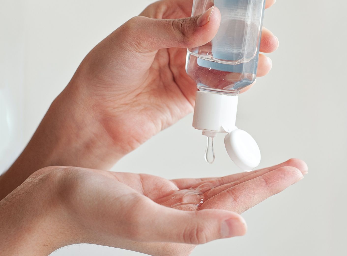 Hands with sanitizer drops for covid-19 prevention