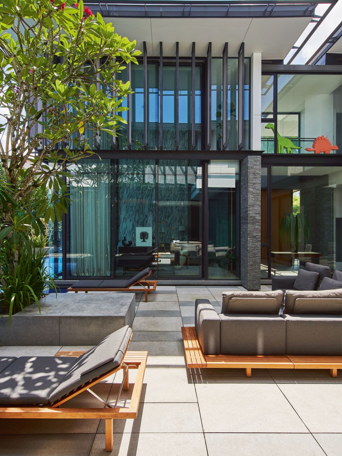 The spacious courtyard is furnished with outdoor sofas and daybeds from Tribù