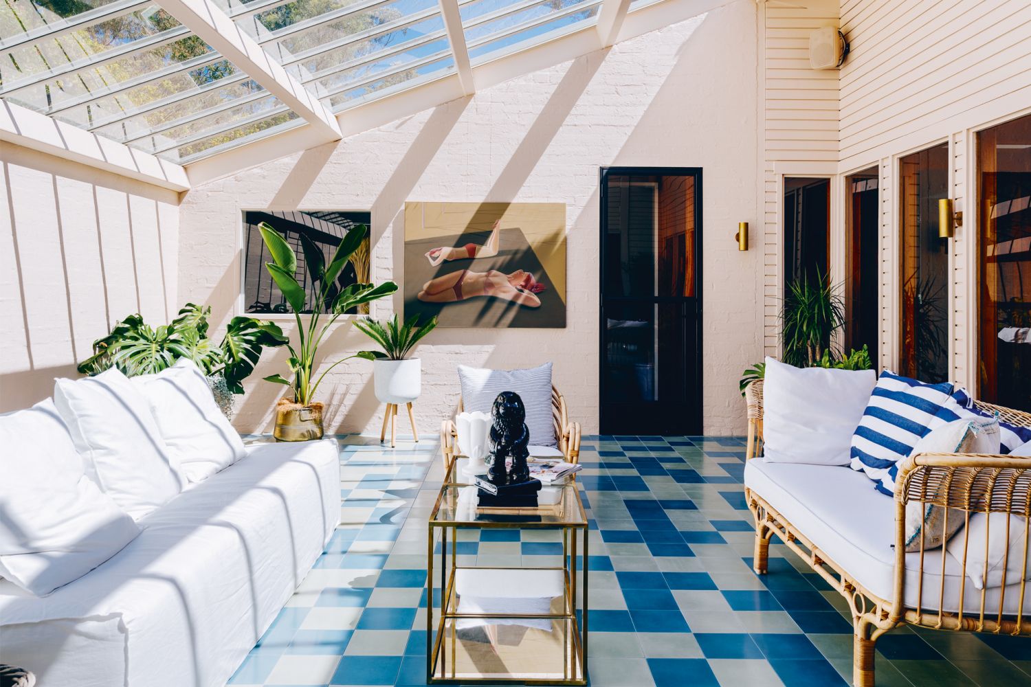 First constructed in the 1970s, this inviting house in Hobart, Australia, features light-filled spaces and blue accents in the living area that are echoed in the colourful kitchen cabinetry