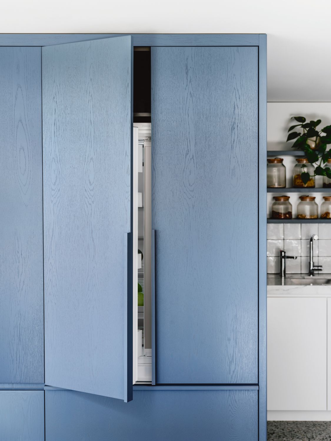 Blue cabinets add pops of colour to the kitchen