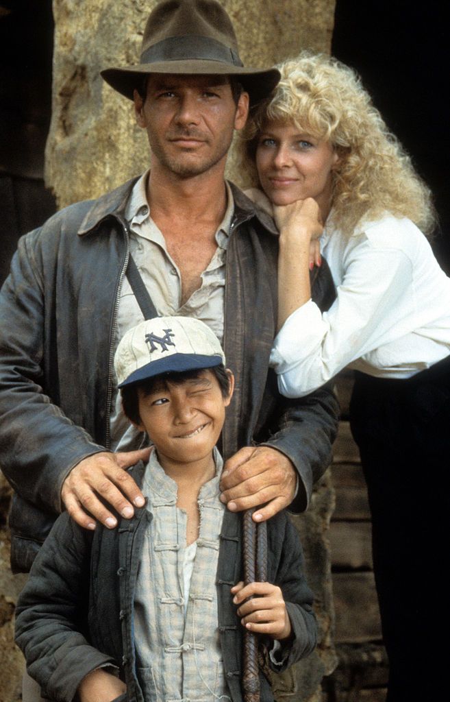 Harrison Ford, Jonathan Ke Quan and Kate Capshaw on set of the film 'Indiana Jones And The Temple Of Doom', 1984. (Photo by Paramount/Getty Images)