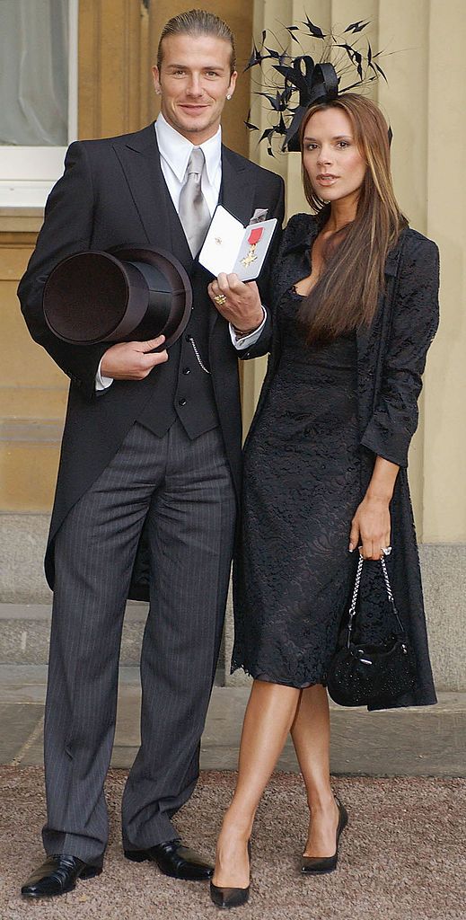 LONDON - NOVEMBER 27: (FILE PHOTO) England football captain David Beckham stands with his wife Victoria, as he shows off the OBE (Officer of the Order of the British Empire) he received from Britain's Queen Elizabeth II at Buckingham Palace on November 27, 2003 in London. David Beckham and former PA Rebecca Loos are under scrutiny for an alleged affair, reported by the News Of The World this weekend. (Photo by ROTA/Getty Images)