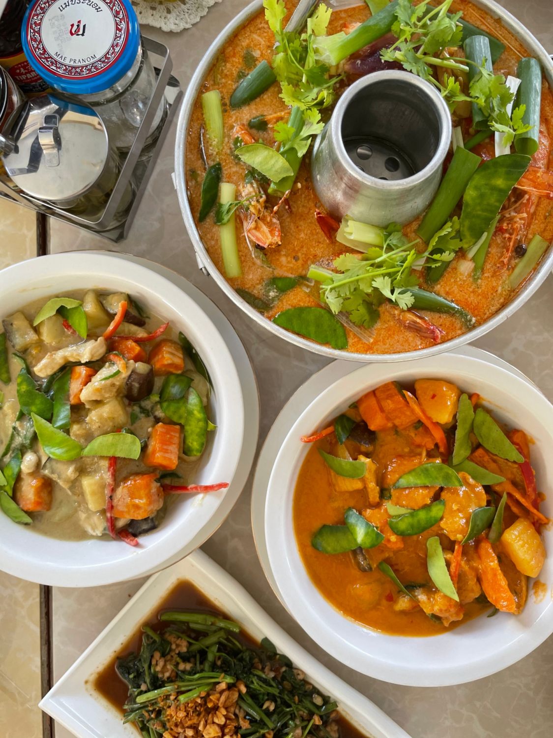 Green curry chicken, red curry pork, stir-fried morning glory, and tom yum kung form Wonderland Thai restaurant