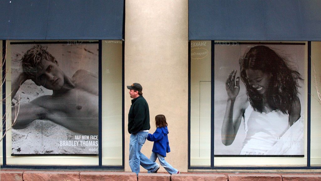 March 29, 2005 / Boulder Colo / Jaime Klomhaus walks with his daughter Storm, 6, in front of Abercrombie & Fitch off of Broadway next to Pearl Street Mall March 29, 2005. (Sammy Dallal / Daily Camera)(Photo by Sammy Dallal/Digital First Media/Boulder Daily Camera via Getty Images)
