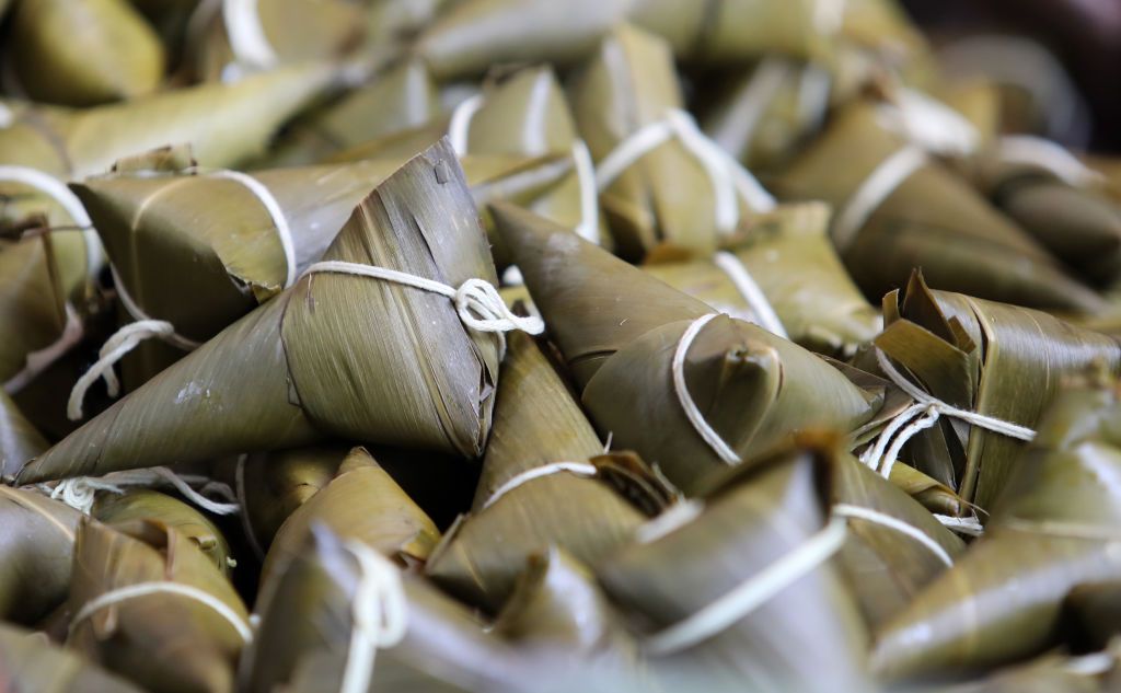 KUNMING, CHINA - JUNE 10: People shop for zongzi, pyramid-shaped glutinous rice dumplings wrapped in reed leaves, at a food market before the Dragon Boat Festival on June 10, 2021 in Kunming, Yunnan Province of China. (Photo by Yang Zheng/VCG via Getty Images)