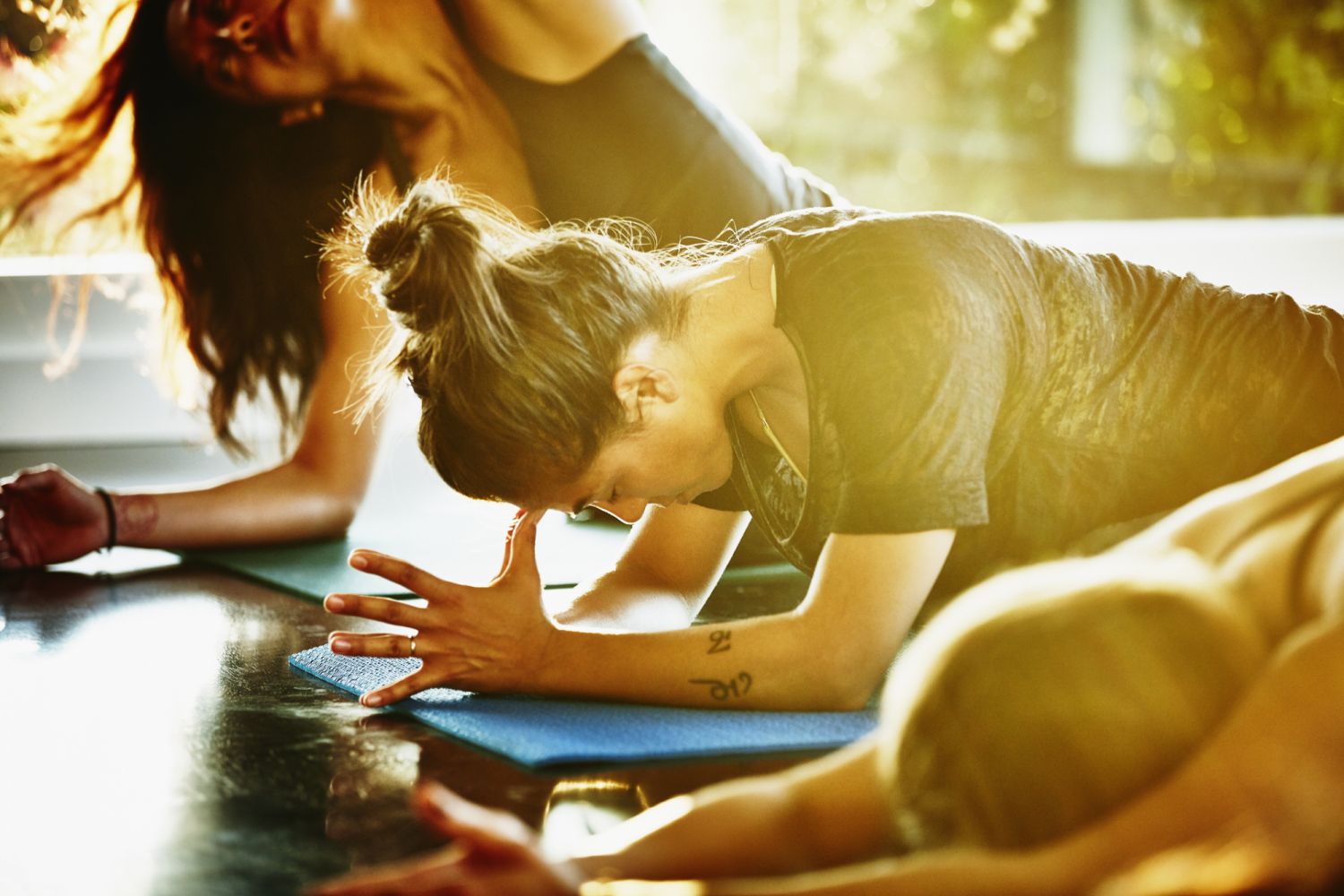 Woman resting between poses in yoga class in studio