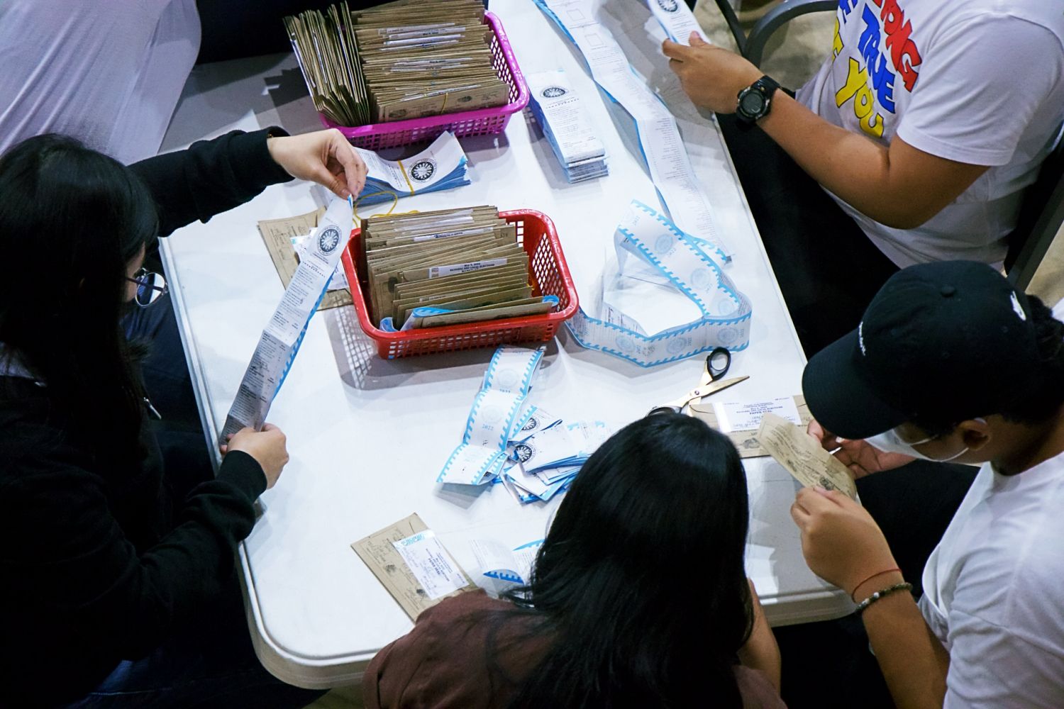 PPCRV volunteers opening the sealed election returns for checking and verifying to be encoded later