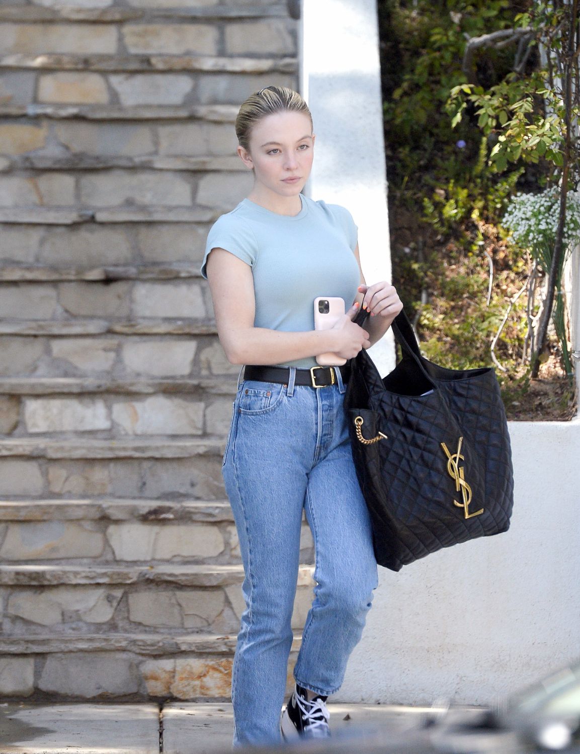 04/18/2022 EXCLUSIVE: Sydney Sweeney is pictured stepping out in Los Angeles. The 24 year old Euphoria actress carried a large YSL bag and wore a green t-shirt, jeans, black belt, and Converse high tops. sales@theimagedirect.com Please byline:TheImageDirect.com*EXCLUSIVE PLEASE EMAIL sales@theimagedirect.com FOR FEES BEFORE USE