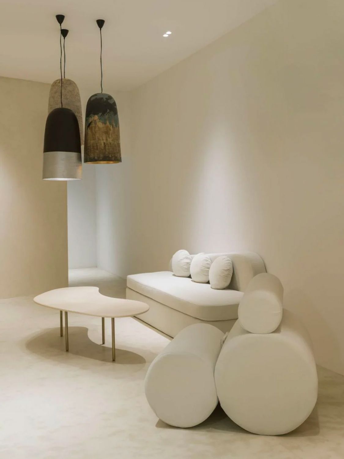 Sculptural lighting can be found throughout the three-storey space